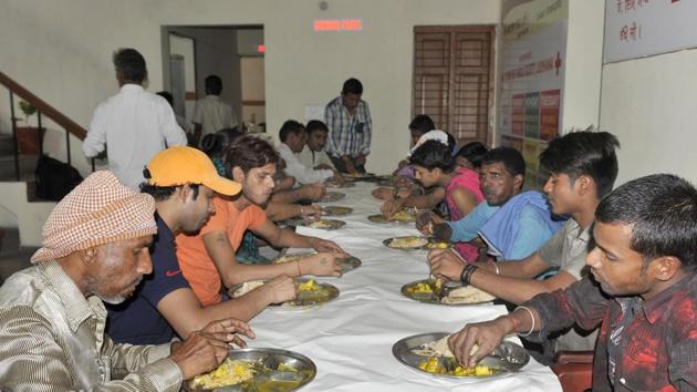 People having food at Saddi Rasoi near Civil Hospital in Ludhiana.(Gurminder Singh /HT)