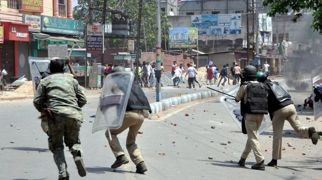 Police and Rapid Action Force personnel trying to stop violent protests against child lifting incident in Mango area in Jamshedpur on Saturday. (PTI Photo) Police and Rapid Action Force personnel trying to stop violent protests against child lifting incident in Mango area in Jamshedpur on Saturday. (PTI Photo)