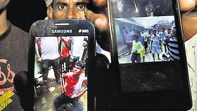 Villagers of Haldipokhar showing videos of lynching gone viral at a late night villagers meeting in East Singhbhum on May 20. (Parwaz Khan/ HT Photo) Villagers of Haldipokhar showing videos of lynching gone viral at a late night villagers meeting in East Singhbhum on May 20. (Parwaz Khan/ HT Photo)