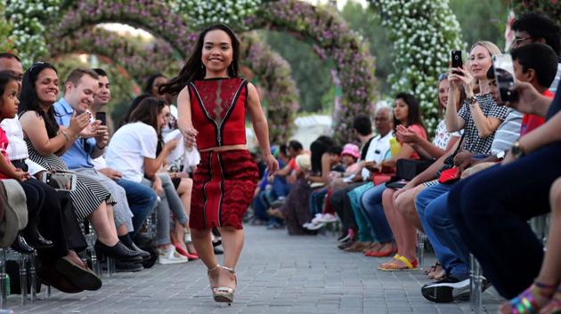 A model walks down the catwalk during the International Dwarf Fashion Show as part of the Arab Fashion Week in the United Arab Emirate of Dubai. Models walk down the catwalk wearing designs by Marchesa during the Arab Fashion Week in the United Arab Emirate of Dubai. (KARIM SAHIB / AFP)