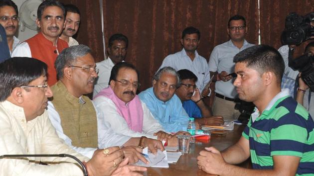 Chief minister Trivendra Singh Rawat interacts with a BJP worker at the party office in Dehradun on Monday. (HT Photo) Chief minister Trivendra Singh Rawat interacts with a BJP worker at the party office in Dehradun on Monday. (HT Photo)