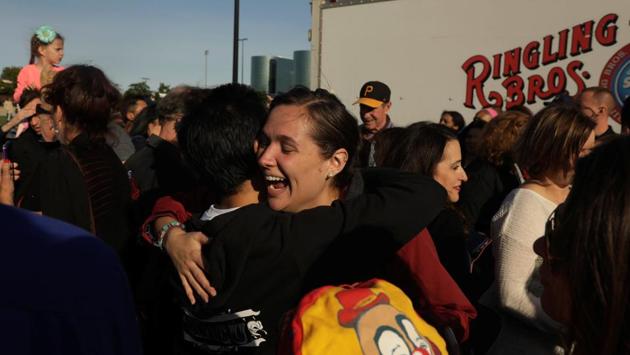 Former employees embrace in front of a trailer before watching the last show . (Lucas Jackson / REUTERS)