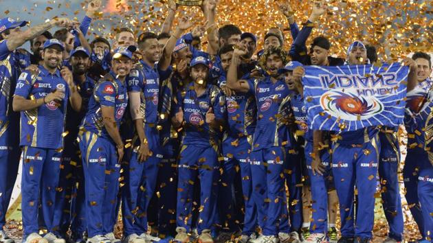 Mumbai Indians players hold the trophy as they celebrate their victory against Rising Pune Supergiant after the 2017 IPL Twenty20 final cricket match at the Rajiv Gandhi International Cricket Stadium in Hyderabad on May 21.(AFP Photo)