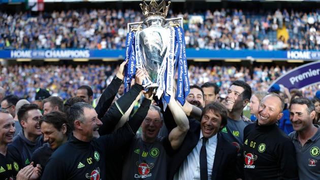 Antonio Conte holds aloft the trophy along with his support staff. (AFP) Antonio Conte holds aloft the trophy along with his support staff. (AFP)