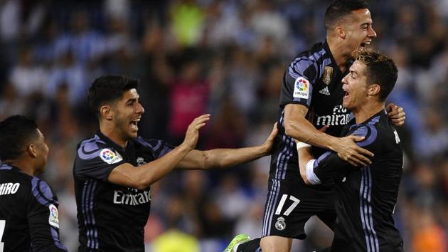 Real Madrid's Cristiano Ronaldo celebrates with teammates after Real Madrid won the La Liga title.(AP)