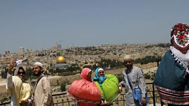 AFTER: Visitors take pictures on the Mount of Olives overlooking Jerusalem's Old City. (Ronen Zvulun / Reuters)