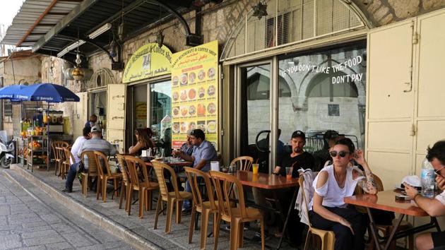 AFTER: People sit at a sidewalk cafe in Jerusalem's Old City. The Palestinians want the eastern part of the city to be the capital of their future state, alongside the West Bank and Gaza. (Ammar Awad / REUTERS)
