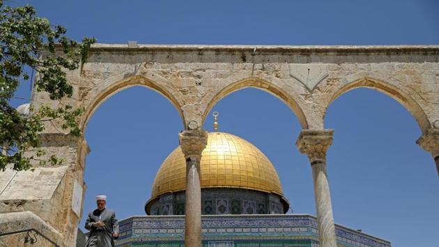 AFTER: A Palestinian man walks down the stairs in front of the Dome of the Rock. Over the decades since 1967, Jerusalem has seen controversy over settlements, violence, and demographic change. (Ammar Awad / REUTERS)