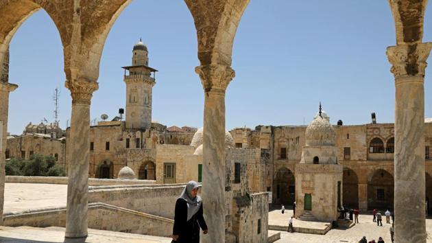 AFTER: A woman walks near an ancient archway and ramp leading to the Qayt Bay fountain or Sabil Qaitbay. Despite all this, many of the key sites in the Old City, scenes of fighting half a century ago, have changed relatively little. (Ammar Awad / REUTERS)