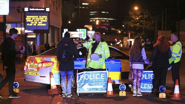 Emergency services work at Manchester Arena after reports of an explosion at the venue during an Ariana Grande gig in Manchester.(AP Photo)