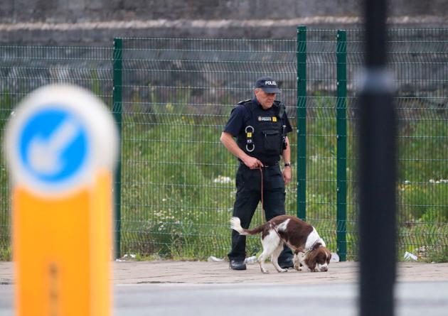 A police officer with a sniffer dog patrols near the Arena. (Danny Lawson / AP Photo)