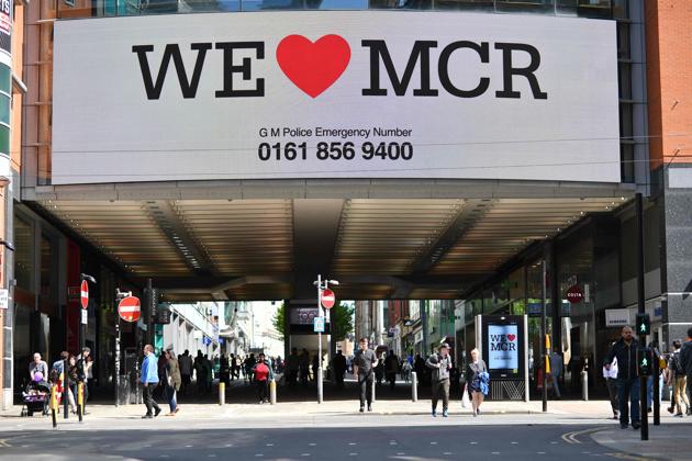 A sign that reads "We Love MCR" is displayed in solidarity above a street in central Manchester, northwest England on May 23, 2017 following a deadly terror attack at Manchester Arena. (Ben STANSALL/AFP Photo)