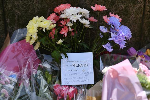 Floral tributes are pictured in St Ann's Square in Manchester, northwest England following the attack on Manchester Arena. (Ben STANSALL/AFP Photo)