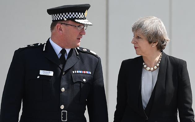 Britain's Prime Minister Theresa May (R) walks with chief constable of Greater Manchester Police, Ian Hopkins as she leaves following their meeting at the police force's headquarters in Manchester, northwest England on May 23, 2017. (Oli SCARFF/AFP)