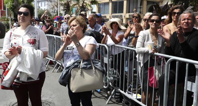 People applaud following a moment of silence for the victims of the Manchester bomb blast, outside the Palais du Festival in Cannes, southern France, Tuesday, May 23, 2017. (Alastair Grant/AP Photo)