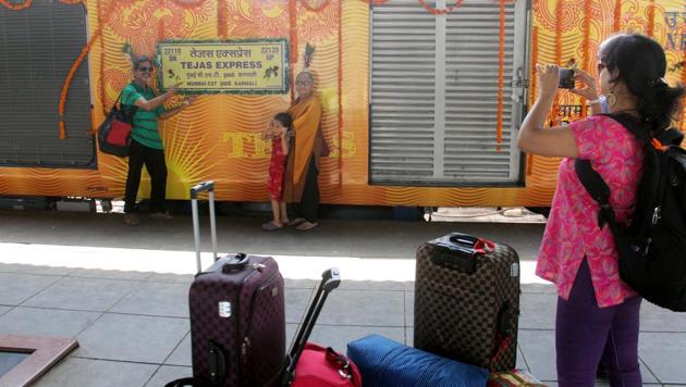 People take photos of the Tejas Express, before it was flagged off from CST on Monday.(Bhushan Koyande/HT)