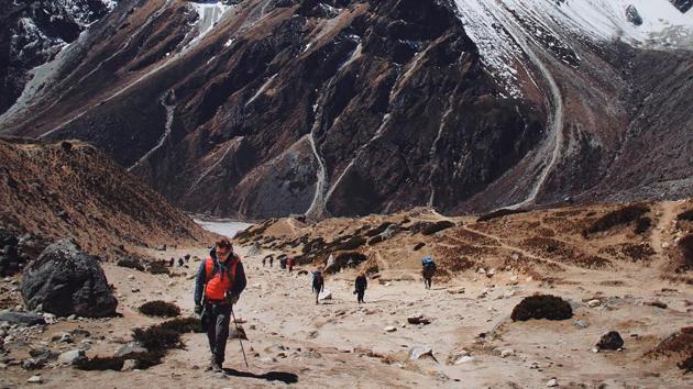 This handout picture released by DJ Paul Oakenfold's SoundTrek on April 10, 2017 and taken on April 8 shows the British artist in Khumjung as he hikes to Mount Everest's base camp ahead of a concert billed as the "highest party on earth". Influential British DJ Paul Oakenfold reached Mount Everest's base camp where he planned to host the ‘highest party on earth’, performing a set at 5,380 meters (17,600 feet). As climbing season in Nepal kicks into gear, few of the mountaineers heading to the world's highest peak were likely expecting to be joined by the three-time Grammy nominated artist and his dance beats. (ANTON NELSON / SOUNDTREK/AFP)