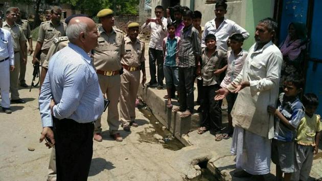 Uttar Pradesh home secretary Mani Prasad Mishra interacts with villagers in Shabeerpur on Wednesday.(Sahendra Pundeer/HT) Uttar Pradesh home secretary Mani Prasad Mishra interacts with villagers in Shabeerpur on Wednesday.(Sahendra Pundeer/HT)