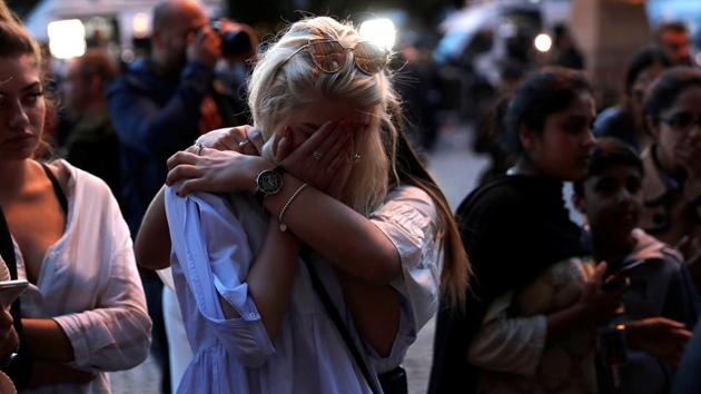 Women react after lighting candles for the victims of the Manchester Arena attack, in central Manchester, May 23. (Reuters Photo) Women react after lighting candles for the victims of the Manchester Arena attack, in central Manchester, May 23. (Reuters Photo)