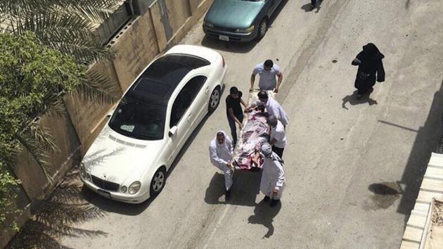 This image provided by an activist who requested to remain unnamed, shows people carrying a man who was injured in a raid on an sit-in, in Diraz, Bahrain, Tuesday, May 23, 2017. Bahrain police raided a town where the sit-in has been going on for months in support of Sheikh Isa Qassim, a prominent Shia cleric, who had his citizenship stripped by the government.(AP Photo)