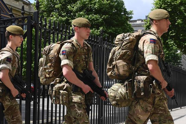 British soldiers enter a defence ministry building near the New Scotland Yard headquarters in London. (AFP) British soldiers enter a defence ministry building near the New Scotland Yard headquarters in London. (AFP)