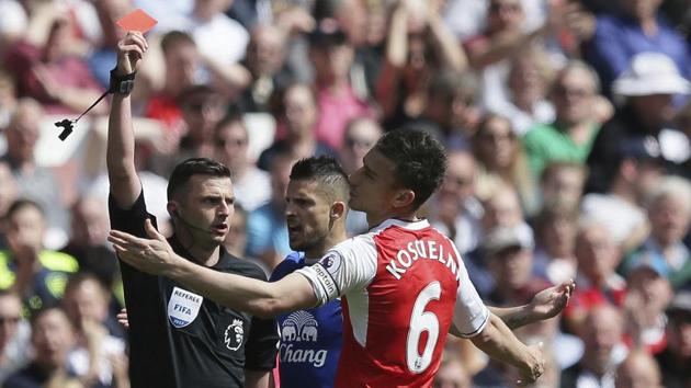 Arsenal's Laurent Koscielny (R) reacts to being shown the red card by referee Michael Oliver during the final game of the season against Everton. (AP) Arsenal's Laurent Koscielny (R) reacts to being shown the red card by referee Michael Oliver during the final game of the season against Everton. (AP)