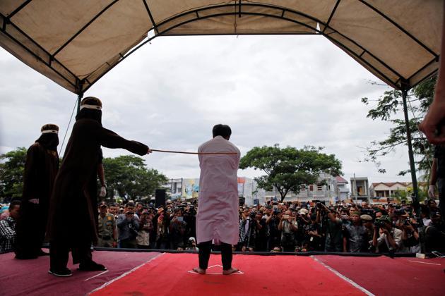An Indonesian man is publicly caned for having gay sex in Banda Aceh, Aceh province, Indonesia. Aceh was granted special rights to introduce its own conservative Sharia laws more than a decade ago and strict laws against homosexuality came into effect in recent years. Gay sex is not illegal in most of Indonesia but it is in Aceh, where perhaps for the first time gay men have been caned under Islamic law in the province. (REUTERS)