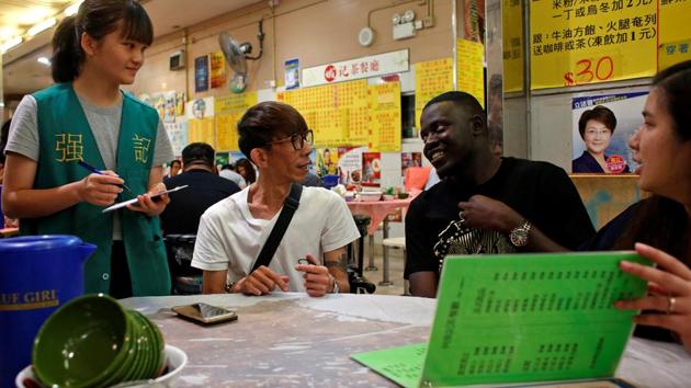 Sarjo Touray (2nd R), 27, from Gambia, All Black FC goalkeeper, orders food during a dinner. The team was set up a year ago by expatriate Medard Koya, a soccer coach from the Central African Republic. (Bobby Yip/REUTERS) Sarjo Touray (2nd R), 27, from Gambia, All Black FC goalkeeper, orders food during a dinner. The team was set up a year ago by expatriate Medard Koya, a soccer coach from the Central African Republic. (Bobby Yip/REUTERS)