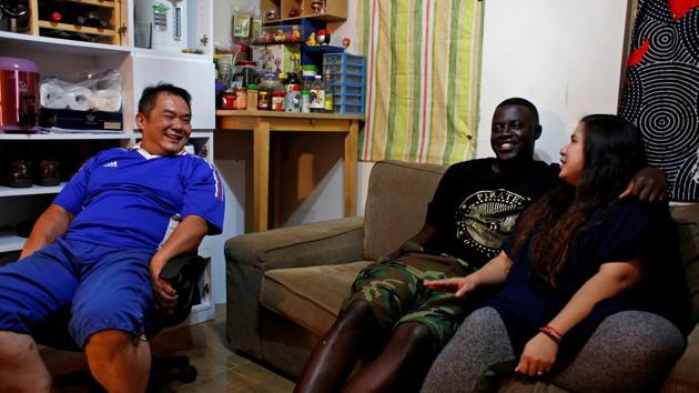Sarjo Touray (C), 27, from Gambia shares a light moment with wife, Yukmi and his father-in-laws at their home in Hong Kong. Human rights lawyer Robert Tibbo says Hong Kong makes it difficult for them to settle permanently in the city. (Bobby Yip/REUTERS) Sarjo Touray (C), 27, from Gambia shares a light moment with wife, Yukmi and his father-in-laws at their home in Hong Kong. Human rights lawyer Robert Tibbo says Hong Kong makes it difficult for them to settle permanently in the city. (Bobby Yip/REUTERS)