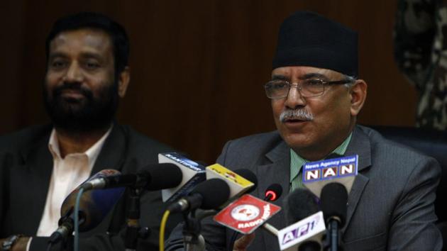 Nepalese Prime Minister Pushpa Kamal Dahal, also known as Prachanda (R), talks with the media at a press conferences on his government's first 100 days in office in Kathmandu on November 11, 2016. / AFP PHOTO / PRAKASH MATHEMA(AFP)