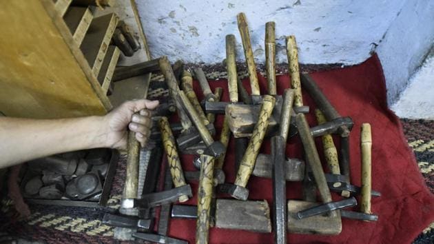 An apprentice shows different kinds of tools which they use in their craft to create gold and silver sculptures. From receiving royal patronage to being exported the world over, beautiful objects painstakingly crafted by their hands continue to receive admiration and accolades. (Burhaan Kinu/HT PHOTO)