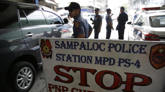 Policemen watches vehicles at a checkpoint in Manila, Philippines as the Philippine National Police is placed under full alert status following the declaration of martial law in Mindanao southern Philippines. (AP Photo) Policemen watches vehicles at a checkpoint in Manila, Philippines as the Philippine National Police is placed under full alert status following the declaration of martial law in Mindanao southern Philippines. (AP Photo)