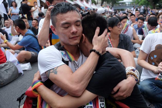 Same-sex activists hug outside the parliament as they celebrate the landmark decision. Crowds of supporters cheered, hugged and wept as the court said current laws preventing the practice “violated” the Constitution’s guarantees of freedom of marriage and equality. (Sam Yeh/AFP) Same-sex activists hug outside the parliament as they celebrate the landmark decision. Crowds of supporters cheered, hugged and wept as the court said current laws preventing the practice “violated” the Constitution’s guarantees of freedom of marriage and equality. (Sam Yeh/AFP)