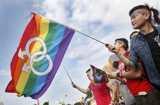 FILE - In this Dec. 10, 2016, file photo, supporters of LGBT and human rights wave rainbow flags during a rally supporting a proposal to allow same-sex marriage. The court said the physical and psychological need for permanent unions was - equally essential to homosexuals and heterosexuals, given the importance of the freedom of marriage to the sound development of personality and safeguarding of human dignity. (Chiang Ying-ying/AP) FILE - In this Dec. 10, 2016, file photo, supporters of LGBT and human rights wave rainbow flags during a rally supporting a proposal to allow same-sex marriage. The court said the physical and psychological need for permanent unions was - equally essential to homosexuals and heterosexuals, given the importance of the freedom of marriage to the sound development of personality and safeguarding of human dignity. (Chiang Ying-ying/AP)
