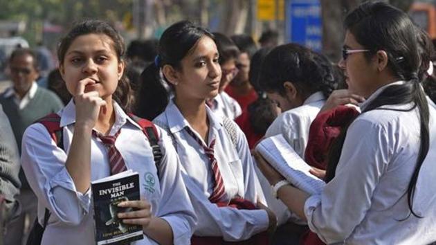 A group of Class 12 students waits outside an exam centre at Delhi’s St Thomas’ School.(HT file photo)