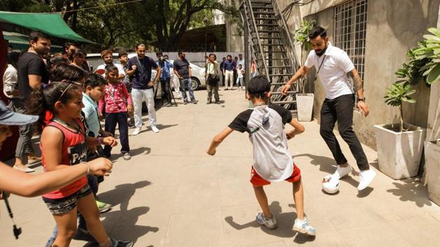 India cricket captain Virat Kohli plays with kids and encouraged them to take up sport. (HT Photo) India cricket captain Virat Kohli plays with kids and encouraged them to take up sport. (HT Photo)