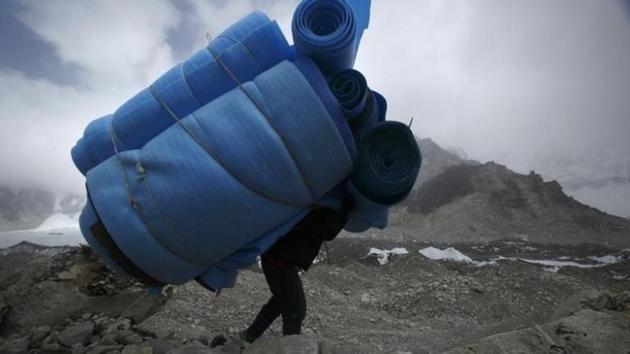 File photo of a porter carrying mattresses from the Everest base camp, approximately 5,300 metres above sea level, in Solukhumbu district of Nepal. (Reuters) File photo of a porter carrying mattresses from the Everest base camp, approximately 5,300 metres above sea level, in Solukhumbu district of Nepal. (Reuters)