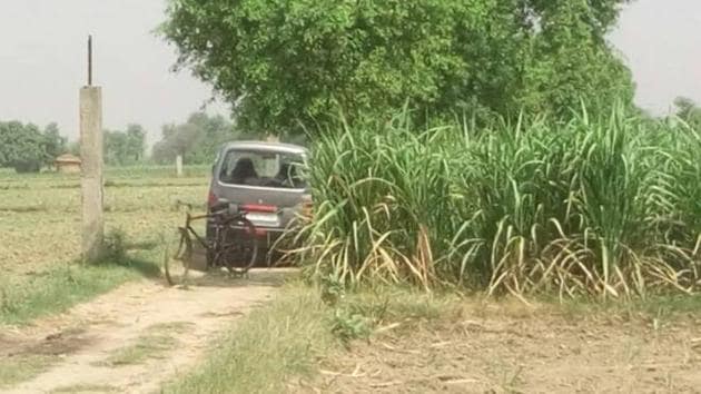 The car the family was travelling in at the spot on the Jewar-Bulandshahr road off the Yamuna expressway.(HT photo)