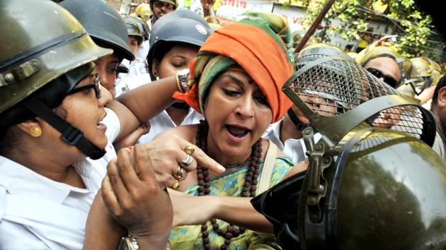 Actress-turned politician and BJP Rajya Sabha MP Rupa Ganguly clashes with the women police personnel during the protest. (PTI) 