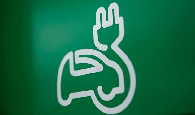 An electric car charging sign is seen at commercial EV charging station. (Reuters file photo) An electric car charging sign is seen at commercial EV charging station. (Reuters file photo)
