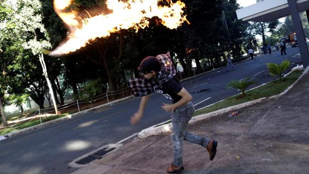 A demonstrator clashes with riot police officers during a protest. (Ueslei Marcelino / Reuters) A demonstrator clashes with riot police officers during a protest. (Ueslei Marcelino / Reuters)