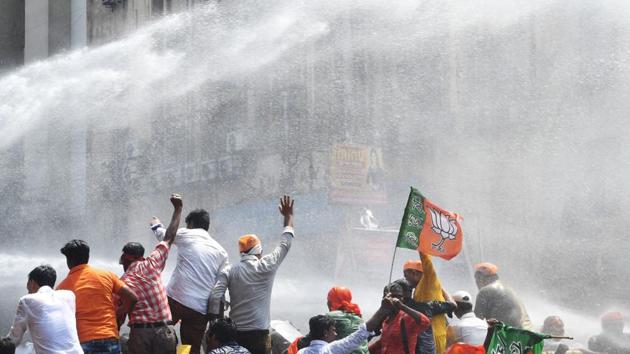 Police personnel  fire  water cannons at activists of the Bhartiya Janata Party (BJP) next to the state police headquarters in Kolkata. The saffron party’s workers, led by Ghosh, marched towards the city police headquarters at Lalbazar in the central part of the city, but were stopped by the police on Brabourne road near their destination. (Dibyangshu  Sarkar/AFP) 