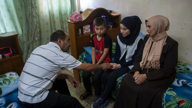 Nour al-Ta'i, a 15-year-old blind resident of East Mosul and participant in "al-Ghad Star", a radio talent contest organized by the al-Ghad studio based in the city of Erbil, sits in her room with her family at their home in Mosul on May 18, 2017. (AFP Photo) Nour al-Ta'i, a 15-year-old blind resident of East Mosul and participant in "al-Ghad Star", a radio talent contest organized by the al-Ghad studio based in the city of Erbil, sits in her room with her family at their home in Mosul on May 18, 2017. (AFP Photo)