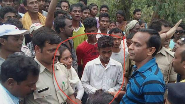 Suspected child lifter (inside the circle) handed over to police by villagers at Sundernagar in Jamshedpur(Manoj Kumar/ HT Photo)