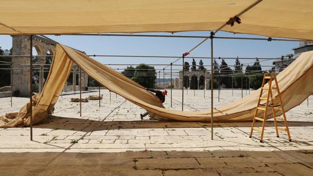 An employee constructs a shade during preparations for the holy month of Ramadan. Hundreds of thousands of Muslim people are expected to visit the mosque to offer prayers during the holy month. (Ammar Awad/REUTERS)