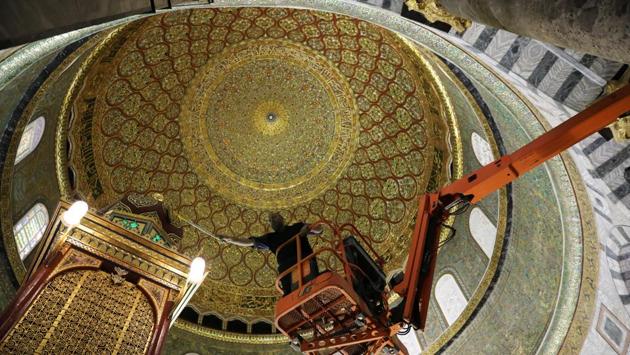 An employee of the Jordanian Waqf, or Islamic trust, that oversees the area, stands on a crane as he cleans the ceiling.Jerusalem buzzes with renewed energy in the days before the start of Ramadan, Islam’s holy month. There’s the bustle to prepare the al-Aqsa Mosque, the 8th-century Muslim shrine in Jerusalem’s Old City, for the hundreds of thousands of Muslims who will come to pray. The Ramzan month is expected to begin from Friday evening. (Ammar Awad/REUTERS)