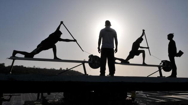 Rowing team members working hard on the ergometer. The game requires rowers to work on building endurance and perfecting their technique of using oars (paddles). (Mujeeb Faruqui/HT Photo)