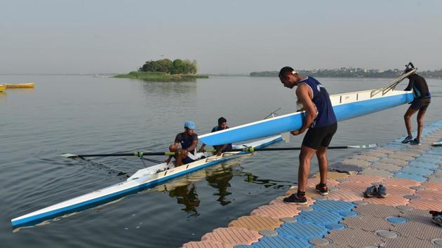 Rowers remove boats from the water after training. The Madhya Pradesh sports department has purchased shells which helps rowers improve performance and was used in the Rio Olympics. (Mujeeb Faruqui/HT Photo)