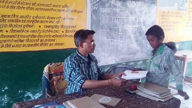 A teacher interacting with a student in the classroom at a government run primary school in Allahabad.(HT photo) A teacher interacting with a student in the classroom at a government run primary school in Allahabad.(HT photo)