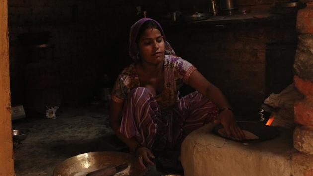 ‘On one hand our Prime Minister is promoting 'Make in India', and on another, we are on the brim of losing our source of income,’ said Dharamvir, a migrant from Rajasthan who shifted to Delhi for a better livelihood. Seen above is Dharamvir’s wife, cooking a family meal in their modest home which is a level below their pottery workshop. (GEETIKA VARSHNEY/HT PHOTO) 